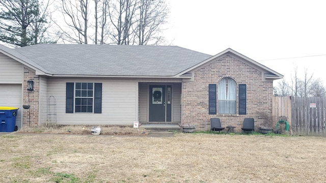 single story home featuring a garage and a front yard