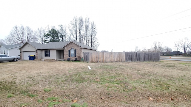 ranch-style house with a front yard and a garage