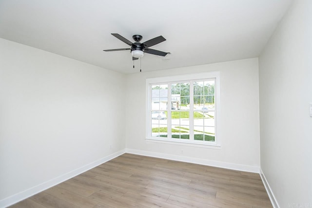 empty room with ceiling fan and light hardwood / wood-style floors