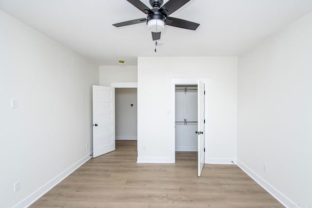 unfurnished bedroom with ceiling fan, a closet, and light hardwood / wood-style floors