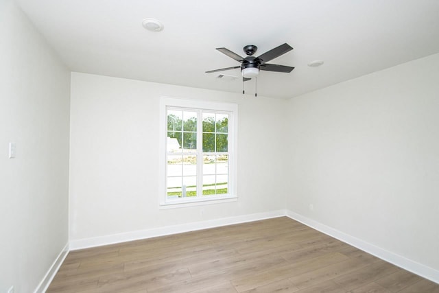 spare room featuring ceiling fan and light wood-type flooring