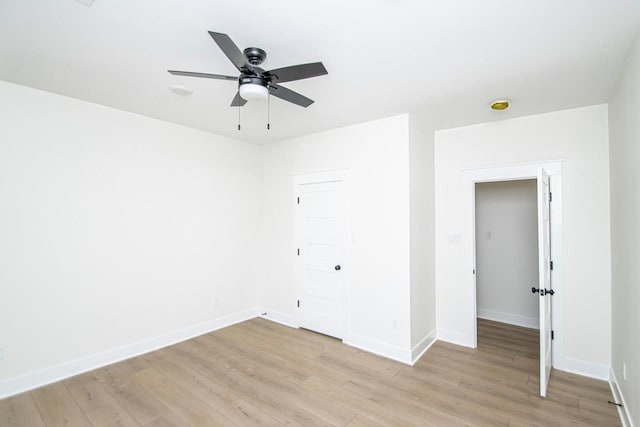 empty room featuring ceiling fan and light wood-type flooring