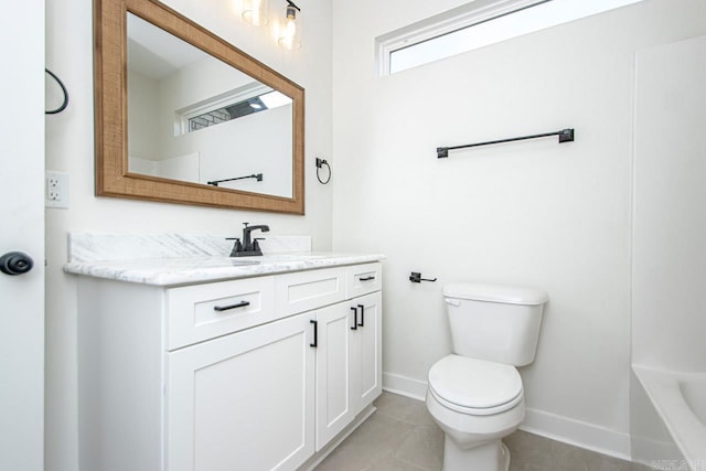 bathroom with toilet, vanity, and tile patterned floors