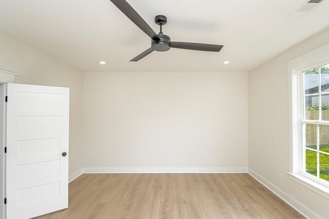 empty room with ceiling fan and light wood-type flooring