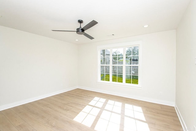 unfurnished room with light wood-type flooring and ceiling fan