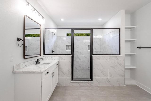 bathroom featuring vanity and a shower with door