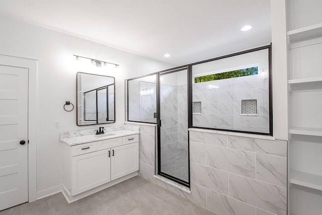 bathroom with tiled shower and vanity