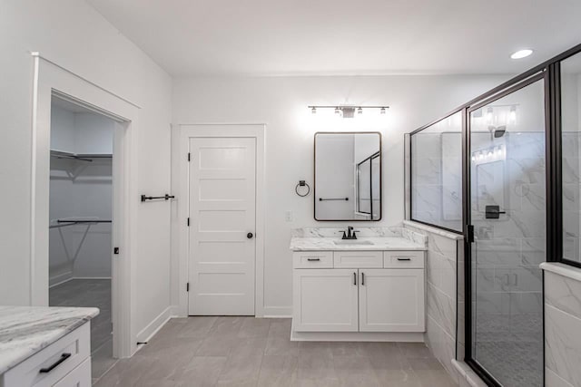 bathroom with vanity, tile patterned flooring, and walk in shower