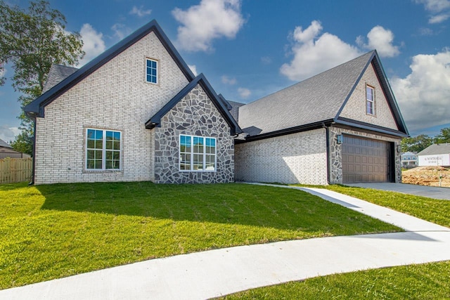 view of front of property featuring a front lawn and a garage