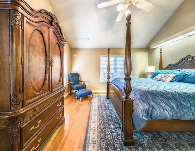 bedroom featuring ceiling fan, lofted ceiling, and light hardwood / wood-style flooring