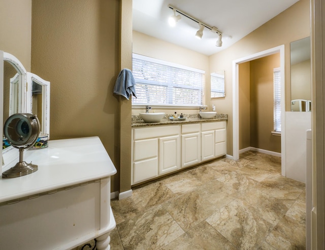 bathroom with vaulted ceiling and vanity