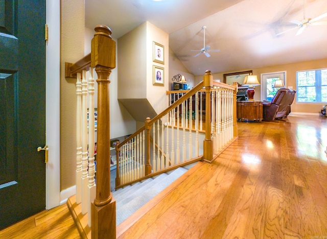 interior space featuring ceiling fan, wood-type flooring, and vaulted ceiling