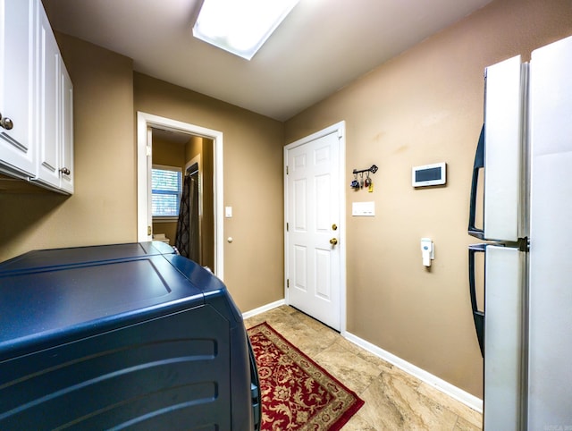 washroom with cabinets and washer / clothes dryer