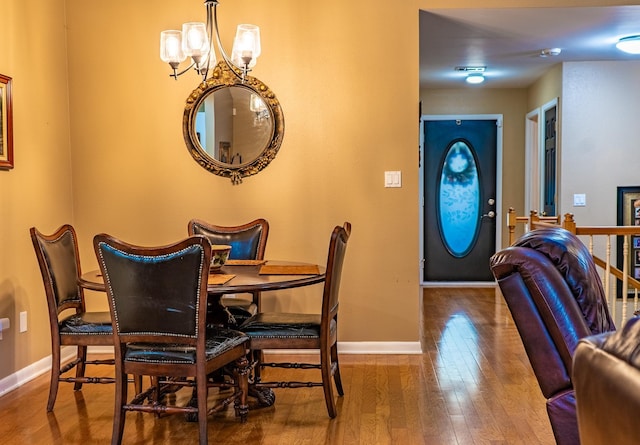 dining space with an inviting chandelier and hardwood / wood-style floors