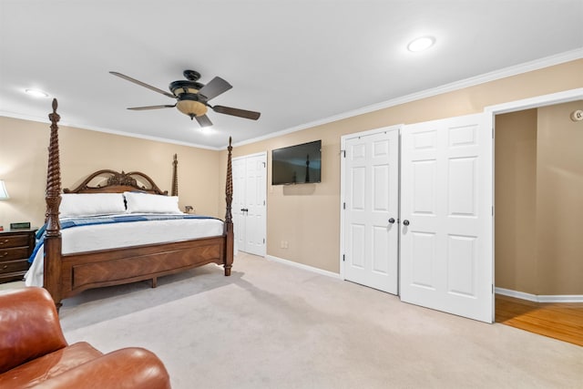 carpeted bedroom with ceiling fan and crown molding