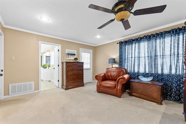 sitting room featuring ceiling fan, carpet, and crown molding