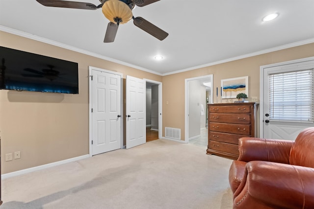 sitting room with ceiling fan, light carpet, and crown molding