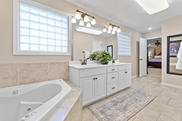 bathroom with ceiling fan, a relaxing tiled tub, tile patterned floors, and vanity