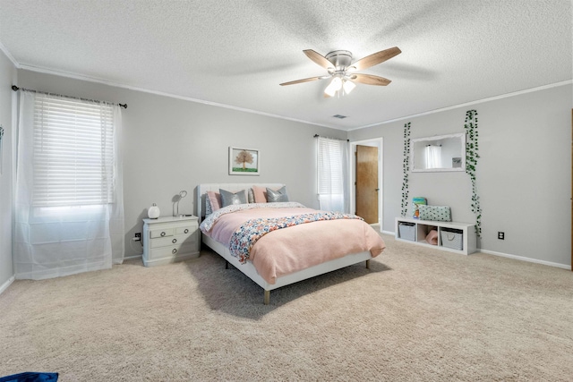 bedroom featuring ceiling fan, carpet floors, ornamental molding, and a textured ceiling