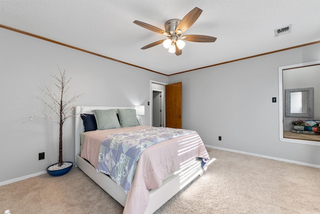 bedroom featuring ceiling fan, light carpet, crown molding, and a textured ceiling