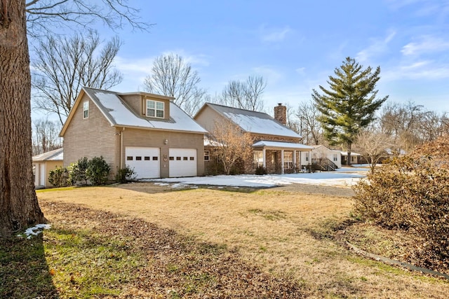 view of front facade with a front yard and a garage