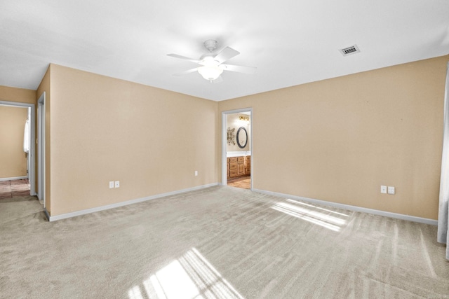 carpeted empty room with ceiling fan