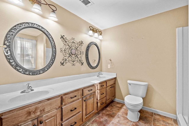 bathroom with toilet and vanity