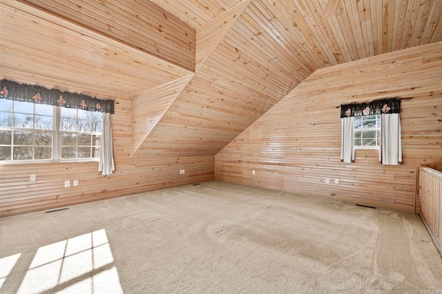 additional living space with carpet, vaulted ceiling, wood ceiling, and wooden walls