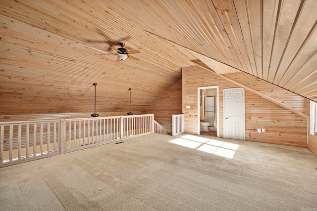 additional living space with lofted ceiling, ceiling fan, wood ceiling, and carpet flooring