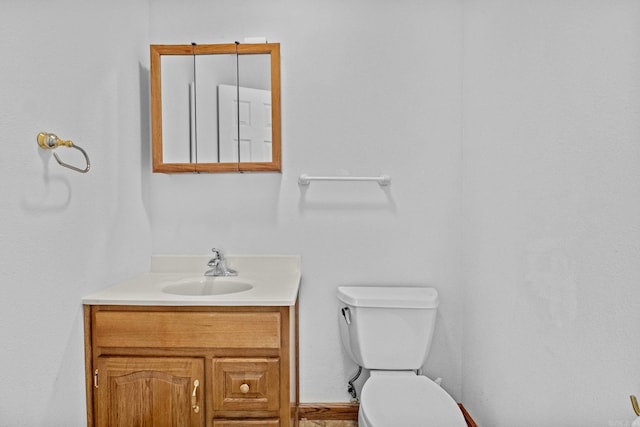 bathroom featuring toilet and vanity