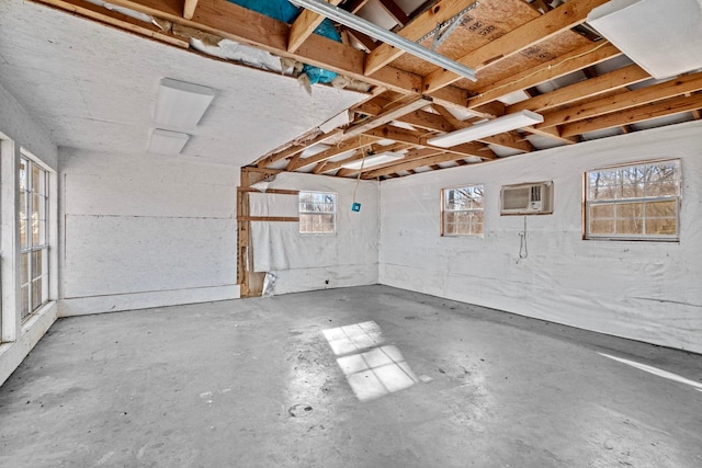 interior space with a wealth of natural light and a wall mounted air conditioner