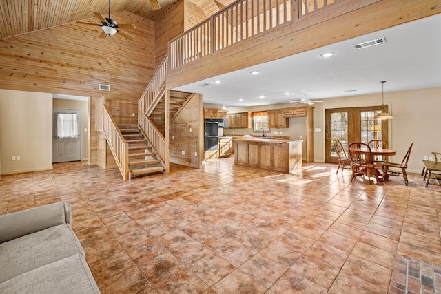 living room featuring ceiling fan, wood ceiling, plenty of natural light, and high vaulted ceiling