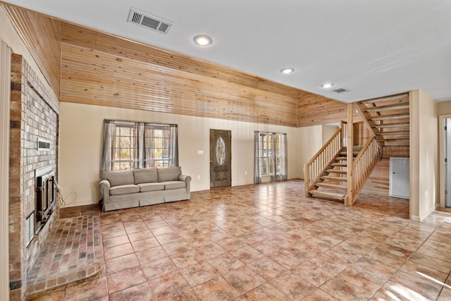 unfurnished living room with wooden ceiling, a fireplace, and wood walls