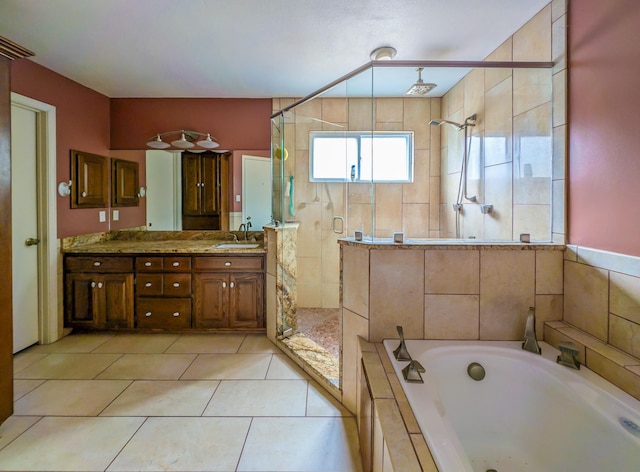 bathroom featuring independent shower and bath, vanity, and tile patterned flooring