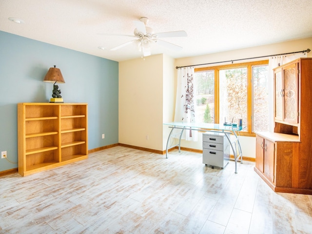 interior space featuring ceiling fan, a textured ceiling, and light wood-type flooring