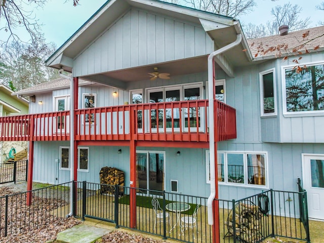 back of house featuring ceiling fan and a balcony