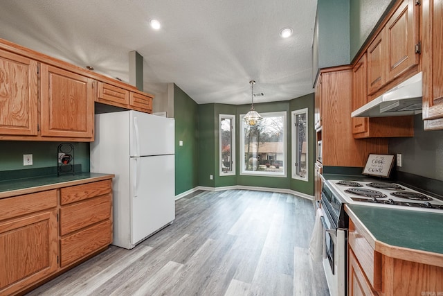 kitchen featuring pendant lighting, white refrigerator, a textured ceiling, and stainless steel range with electric stovetop