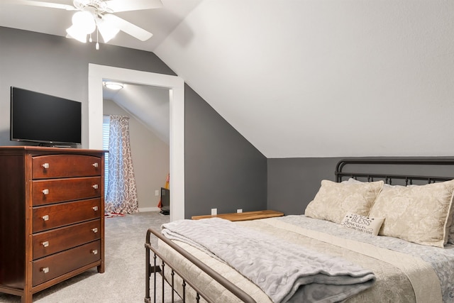 bedroom with ceiling fan, light colored carpet, and vaulted ceiling