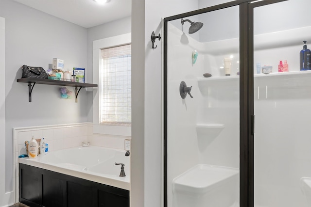 bathroom featuring shower with separate bathtub