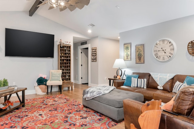 living room featuring ceiling fan, light hardwood / wood-style flooring, and lofted ceiling with beams