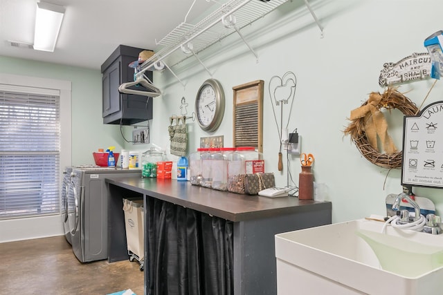 laundry room featuring cabinets, independent washer and dryer, and sink