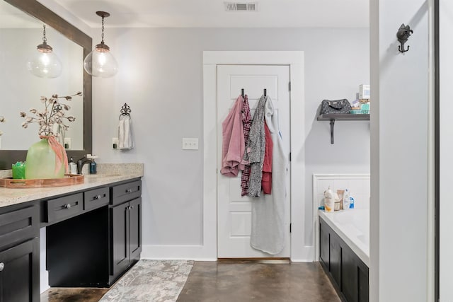 bathroom with vanity, a bath, and concrete flooring