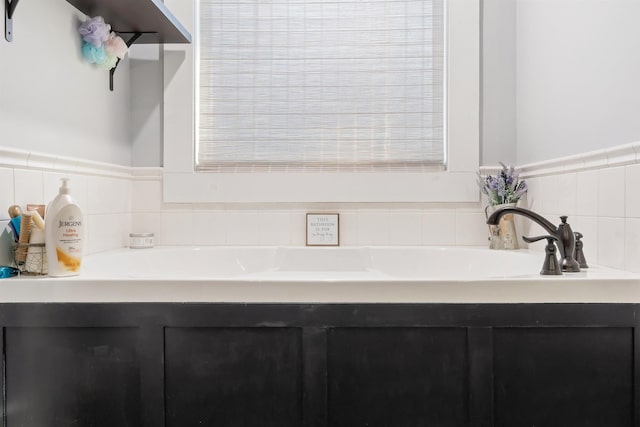 bathroom with a bathing tub and a healthy amount of sunlight