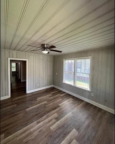 spare room with ceiling fan and dark hardwood / wood-style flooring