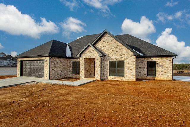 french provincial home featuring a garage and a front lawn