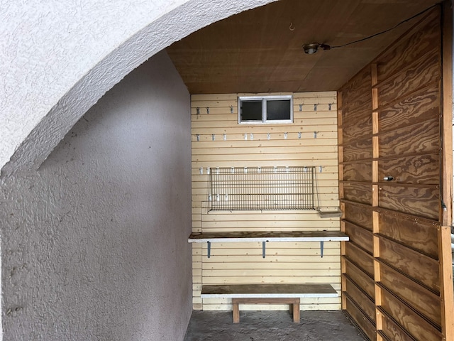 interior space featuring wooden walls