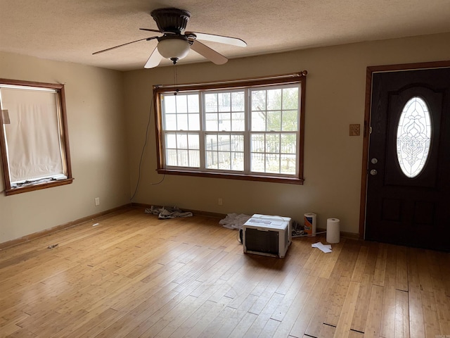 entrance foyer with ceiling fan, light hardwood / wood-style floors, and a textured ceiling