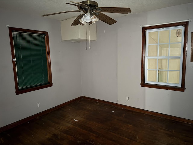 unfurnished room with ceiling fan and dark hardwood / wood-style flooring