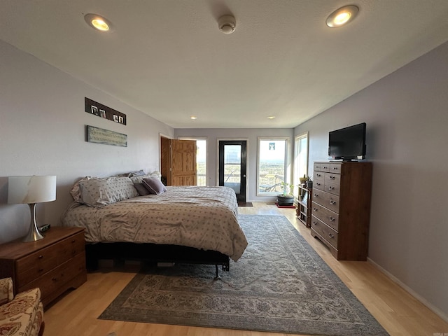 bedroom featuring access to outside and light wood-type flooring