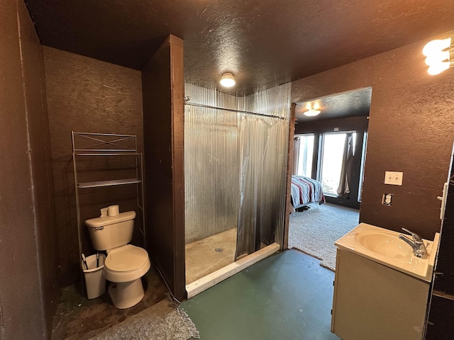 bathroom featuring toilet, a textured ceiling, a shower with curtain, and vanity